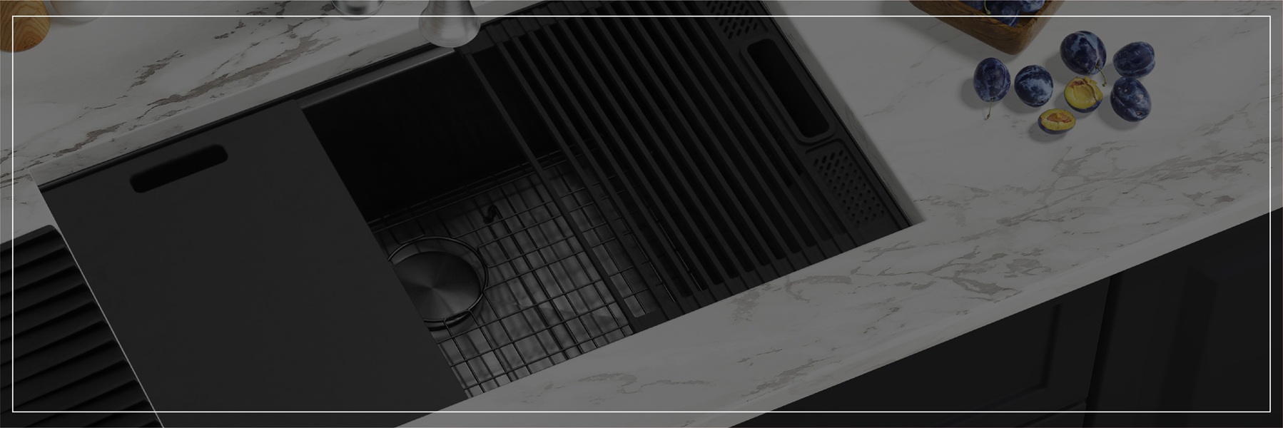 Workstation stainless sink with black accessories in modern setting